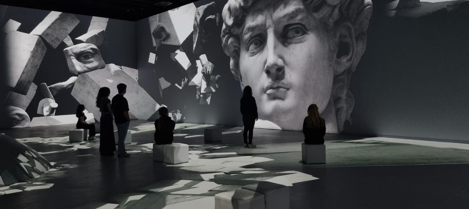 Life-size reconstructed workshops of Leonardo and Michelangelo — notebooks, machines, marble and chisels